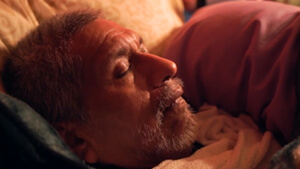 Corporate Giving Video Image Poster - Man On Death Bed